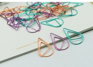 Macro detail of tear-drop shaped paper clips in rose gold, purple and turquoise metal
