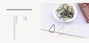 Close-up of teardrop and triangle metal paper clips in gold, silver, and black finish