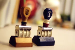 Macro view of vintage rolling date stamps with wooden handle and Eiffel Tower design