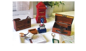 Close-up of vintage wooden rolling date stamp and retro stationery items on a white desk