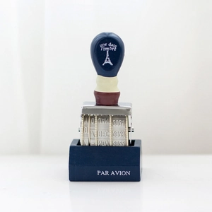 Vintage wooden rolling date stamp with metal frame and Par Avion base for planners