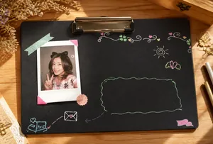 Creative DIY black scrapbook layout featuring colorful pen drawings and Polaroid photos