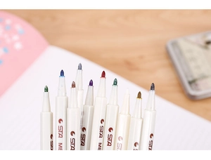 Macro shot of 10 assorted metallic markers tips arranged neatly on a wooden desk