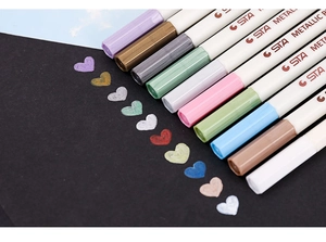 Close-up of 10-color metallic markers showing high coverage on black paper surface