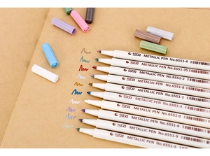 Close-up of STA No.6551 metallic pens showing fine tips and colorful ink strokes