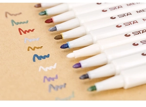 Detailed close-up of STA metallic markers showing fiber tips and shiny ink strokes on paper