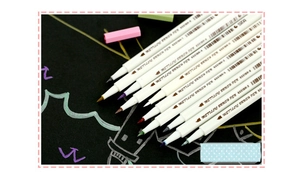 Close-up of 10 metallic brush pens showing soft brush tips and ink colors on black paper