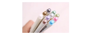 Close-up of STA metallic markers showing vibrant colors and shimmering cap details