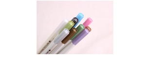 Macro detail of multi-color metallic brush pens with ergonomic hexagonal barrels