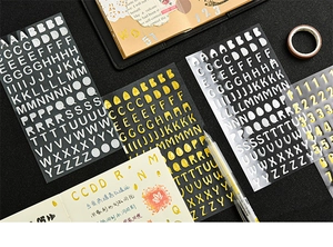 Close-up of metallic gold and silver alphabet stickers for DIY scrapbook journals