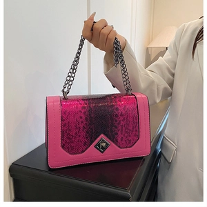 Close-up of rose red and purple snakeskin crossbody bag with diamond metal lock