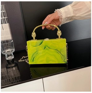 Detail of green marbled acrylic box bag with gold handle and chain strap