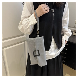 Chic leopard print envelope clutch featuring a matte black square buckle and wristlet