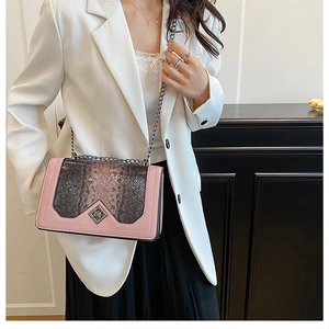 Detail showing pink leather and grey snake pattern patchwork with a chain strap