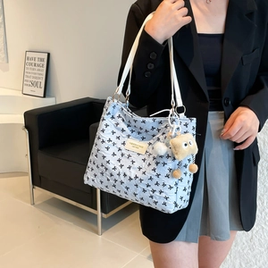 Bolso tote azul claro con estampado de lazos negros y colgante de peluche para mujer