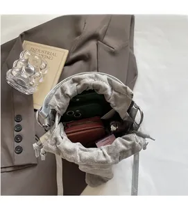 Detail view of the spacious interior of this grey drawstring bucket bag with essentials