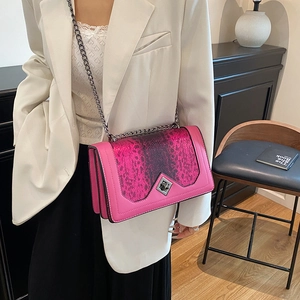 Chic pink snake-print crossbody bag with dark grey chain strap and diamond-shaped lock