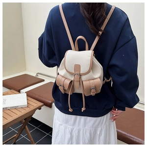 Dettaglio dello zaino in tela vintage con finiture in pelle e doppie tasche con fibbia