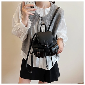 Dettaglio mini zaino vintage nero con chiusura a coulisse e due tasche frontali con fibbia