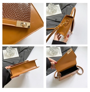 Detail view of brown embossed leather handbag showing gold lock and internal compartment