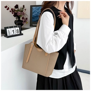 Close-up of khaki tote bag texture with metal buckle and fashion logo detail