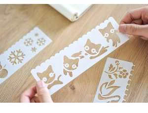 Detailed view of flexible semi-transparent stencils with cartoon cat and floral patterns