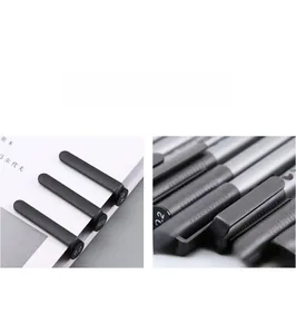 Detail view of professional technical drawing pens with anti-slip clips and tip sizes