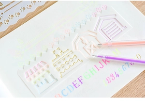 Detailed view of hollow drawing stencil ruler with alphabet letters and house outlines