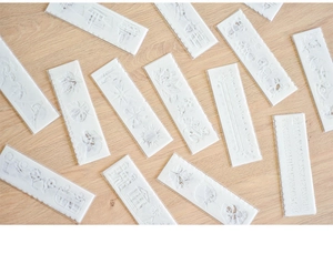 Macro shot of flexible plastic stencils with alphabet and decorative floral patterns