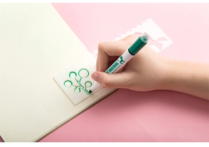 Detail of white hollow drawing stencil with green marker for DIY journaling use