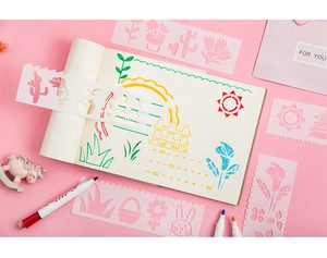 Detail of pink hollow drawing stencils with markers for kids DIY planners and crafts