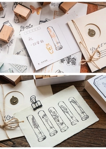 Macro shot of vintage wooden stamp set showing botanical test tube patterns and ink prints