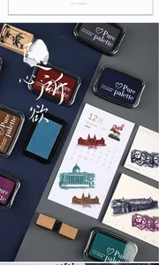 Flat lay of colorful pigment ink stamp pads with vintage stamps and journals