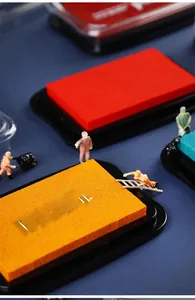 Macro shot of thick sponge pads in vibrant colors with creative miniature workers figurines