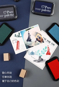 Detail view of various ink pads showing vintage color pigments on a postcard