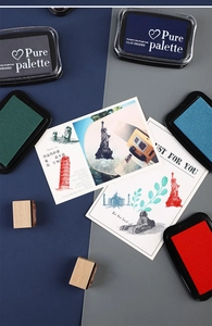 Flat lay of vintage multi-color pigment ink pads and wooden stamps for DIY crafts