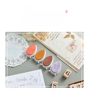 Macro shot of colorful water-drop ink pads with sponge texture on vintage stationery desk