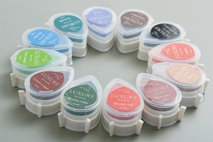 Close-up of teardrop-shaped colorful ink pads for stamps arranged in a neat circular layout