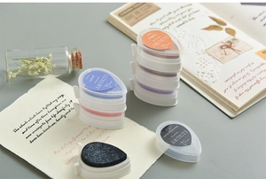 Macro detail of drop-shaped pigment ink pads in various colors for rubber stamps