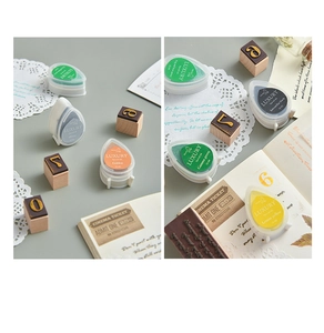 Macro detail of teardrop ink pads in gold and silver for vintage rubber stamps