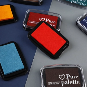 Flat lay of colorful pigment ink stamp pads with transparent lids for DIY crafting