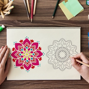 Mandala coloring book on wooden desk with colored pencils and detailed line art patterns