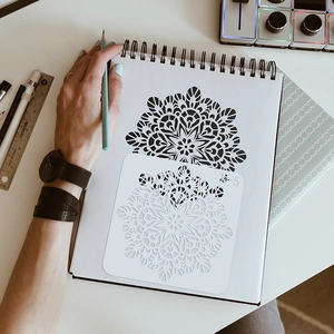 Reusable mandala stencil M-5 for drawing intricate patterns on a spiral notebook