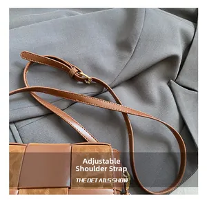Close-up of checkerboard weave on a brown crossbody bag with adjustable shoulder strap