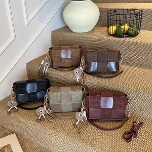 Handwoven leather crossbody bags in five colors with animal print panels and pompom charms
