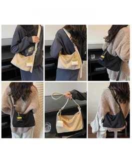 Detailed model showcase of suede hobo bags in black and beige with mini bag charms