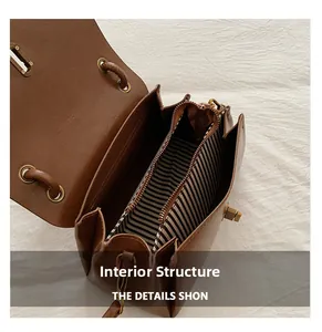Top view showing the striped lining and zippered inner compartment of the brown leather bag