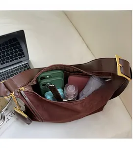 Detail view of the spacious interior of a brown suede and leather Boston bag