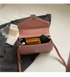 Top view of pink leather crossbody bag interior showing spacious main compartment