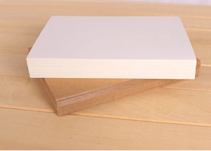 Close-up of stacked thick white and brown kraft blank cards on a light wooden background